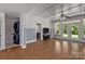 Finished basement with hardwood floors, laundry area, and access to backyard at 7230 Timber Ridge Dr, Mint Hill, NC 28227