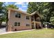 Two-story house with tan siding, a balcony, and a landscaped yard at 7230 Timber Ridge Dr, Mint Hill, NC 28227