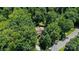 House nestled in a wooded area, providing privacy and nature views at 7230 Timber Ridge Dr, Mint Hill, NC 28227