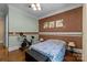 Bedroom with hardwood floors, exercise bike and decorative wall at 7230 Timber Ridge Dr, Mint Hill, NC 28227