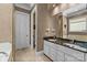 Bathroom with double vanity, granite countertop, and separate toilet area at 7230 Timber Ridge Dr, Mint Hill, NC 28227
