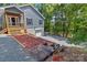 Gray house exterior with wooden stairs, landscaping, and gravel driveway at 1015 Fairfield Rd # 493, Mount Gilead, NC 27306