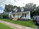 White house with front porch and mature trees at 505 Cemetary St, Salisbury, NC 28144
