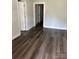 Living room with dark laminate floors and neutral walls at 505 Cemetary St, Salisbury, NC 28144