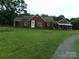 Brick ranch house with attached carport, offering curb appeal at 14004 Elm St, Stanfield, NC 28163