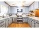 Gray kitchen with stainless appliances and wood floor at 202 Division Ave, Rockwell, NC 28138