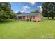 Brick ranch house with a large green lawn at 202 Division Ave, Rockwell, NC 28138