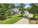 White farmhouse exterior with a large lawn and driveway at 5811 Kristi Ln, Midland, NC 28107