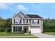 Two story home with gray siding, two-car garage, and landscaping at 219 Coronado Ave # 59, Matthews, NC 28104