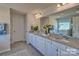 Elegant bathroom with double vanity, granite countertop, and large mirror at 219 Coronado Ave # 59, Matthews, NC 28104