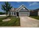 Gray siding home with stone accents, landscaping, and a two-car garage at 112 Asher Ln, Mooresville, NC 28115