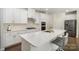 Modern kitchen with white cabinets, quartz countertops, and stainless steel appliances at 168 Ravensara Ave, Fort Mill, SC 29715