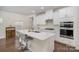 Modern kitchen with white cabinets, quartz countertops, and island at 168 Ravensara Ave, Fort Mill, SC 29715