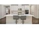 Modern kitchen with white cabinets, quartz countertops, and stainless steel appliances at 168 Ravensara Ave, Fort Mill, SC 29715