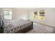 Bedroom with a queen-size bed and two large windows offering natural light at 168 Ravensara Ave, Fort Mill, SC 29715