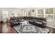 Spacious living room featuring hardwood floors, sectional sofa, and large windows at 168 Ravensara Ave, Fort Mill, SC 29715