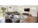 Living room with hardwood floors, sectional sofa, and access to backyard at 168 Ravensara Ave, Fort Mill, SC 29715