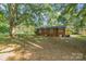 Brick home with a large backyard, mature trees, and grassy areas at 7714 Old Waxhaw Monroe Rd, Waxhaw, NC 28173