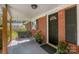 Inviting front porch with swing and potted plants at 7714 Old Waxhaw Monroe Rd, Waxhaw, NC 28173