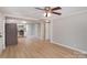 Open living area with kitchen view and wood-look floors at 7714 Old Waxhaw Monroe Rd, Waxhaw, NC 28173