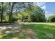 House with large yard and driveway, surrounded by trees at 7714 Old Waxhaw Monroe Rd, Waxhaw, NC 28173