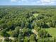 Farmhouse style home with a long driveway at 7714 Old Waxhaw Monroe Rd, Waxhaw, NC 28173
