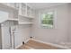 Laundry area with built-in shelving and window at 7714 Old Waxhaw Monroe Rd, Waxhaw, NC 28173