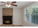 Cozy living room featuring a brick fireplace and large windows at 7714 Old Waxhaw Monroe Rd, Waxhaw, NC 28173