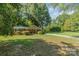 Ranch home surrounded by lush green trees and lawn at 7714 Old Waxhaw Monroe Rd, Waxhaw, NC 28173