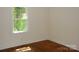 Bright bedroom with hardwood floors and a large window overlooking trees at 203 West Dr, Albemarle, NC 28001
