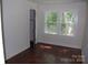 Bedroom with hardwood floors, a closet, and large windows at 203 West Dr, Albemarle, NC 28001