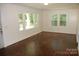 Living room with hardwood floors and large windows at 203 West Dr, Albemarle, NC 28001