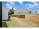 Landscaped backyard with wooden retaining wall at 29060 Low Country Ln, Lancaster, SC 29720