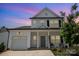 Two-story white house with gray roof, front porch, and attached garage at 29060 Low Country Ln, Lancaster, SC 29720