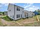 House exterior showcasing a light-colored siding, landscaping and backyard at 29060 Low Country Ln, Lancaster, SC 29720