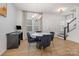 Dining room with hardwood floors, round table, and view into kitchen at 29060 Low Country Ln, Lancaster, SC 29720