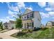 Two-story white house with gray roof, front porch, and attached garage at 29060 Low Country Ln, Lancaster, SC 29720