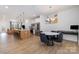 Bright dining room with hardwood floors, round table, and modern chandelier at 29060 Low Country Ln, Lancaster, SC 29720