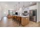 Modern kitchen with island, stainless steel appliances, and light wood cabinets at 29060 Low Country Ln, Lancaster, SC 29720