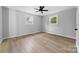 Bright bedroom with wood-look floors and ceiling fan at 115 E Georgia Ave, Bessemer City, NC 28016