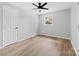 Well-lit bedroom featuring wood-look floors and a ceiling fan at 115 E Georgia Ave, Bessemer City, NC 28016