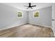 Well-lit bedroom with light gray walls and wood-look flooring at 115 E Georgia Ave, Bessemer City, NC 28016