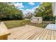 Back deck view with wooden railing and a storage shed in the backyard at 115 E Georgia Ave, Bessemer City, NC 28016