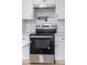 Modern kitchen features stainless steel appliances and white cabinets at 115 E Georgia Ave, Bessemer City, NC 28016