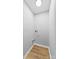 Small laundry room with light gray walls and wood-look flooring at 115 E Georgia Ave, Bessemer City, NC 28016