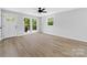 Living room with hardwood floors, white door and large windows at 115 E Georgia Ave, Bessemer City, NC 28016