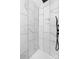Clean shower with marble-look tile in white and gray at 115 E Georgia Ave, Bessemer City, NC 28016