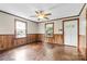Living room with wood floors, ceiling fan, and wood paneling at 323 20Th St, Kannapolis, NC 28083