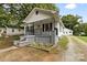 White bungalow with a front porch and yard at 323 20Th St, Kannapolis, NC 28083