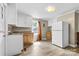 Small kitchen with white cabinets, wood countertops, and vinyl flooring at 323 20Th St, Kannapolis, NC 28083